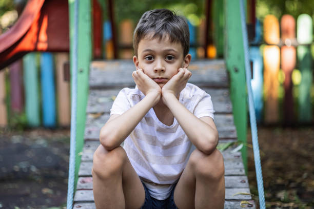 Mother observing early signs of autism in young child at home
